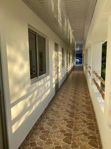 an empty hallway of a building with a tile floor at Ecohotel La Reserva in Piojó