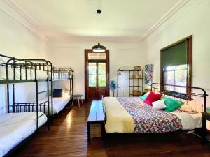 a bedroom with two bunk beds and a table at Linden Lodge in Linden