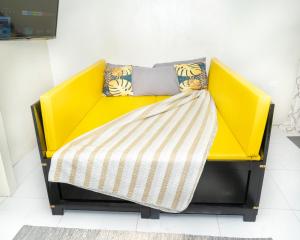 a yellow couch with pillows on it in a room at Francis Nook Belle Garden Room in San Juan