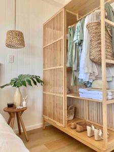 a room with a wooden bunk bed with clothes at Alby’s - Cotton Tree in Maroochydore