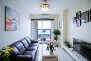 a living room with a couch and a television at Penhouse 4 ngủ View biển rộng 160m2 in Ha Long