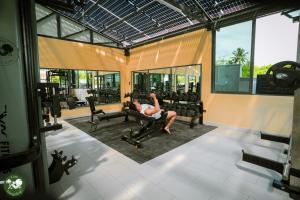 a man is lying on a bench in a gym at LAM BUNGALOW Resort & Spa in Phu Quoc