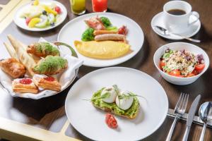 a table with plates of food and a cup of coffee at The Westin Yokohama in Yokohama