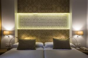 Posteľ alebo postele v izbe v ubytovaní Hotel Comfort Dauro 2