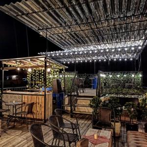 un patio con sillas y mesas y un bar en Hotel & Rooftop Farallones, en Betania