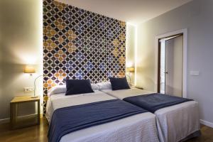 Posteľ alebo postele v izbe v ubytovaní Hotel Comfort Dauro 2