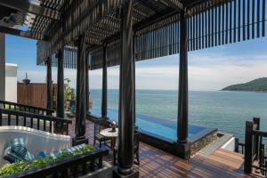 a view of the ocean from a house with a bathtub at InterContinental Danang Sun Peninsula Resort by IHG in Danang