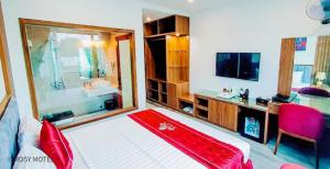 a bedroom with a large bed and a television at Rosy Hotel Dương Nội in Hà Ðông