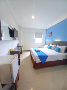Postel nebo postele na pokoji v ubytování Pratama Hotel & Convention Mataram