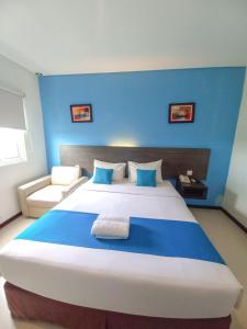 Postel nebo postele na pokoji v ubytování Pratama Hotel & Convention Mataram