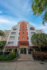 a large building with an orange and white at Bella Villa Pattaya 3rd Road in Pattaya