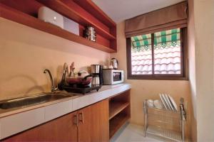 a kitchen with a sink and a microwave at Rak Samui Residence in Bophut 