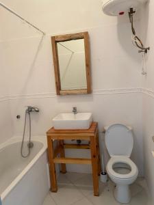 a bathroom with a sink and a toilet and a mirror at Anir of sea tamraght in Agadir