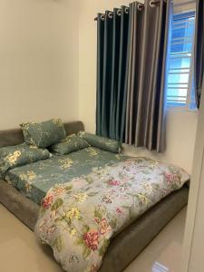 a bed with a blanket on it in a room at SKY LAKE RESIDENCY, PUTRA PERDANA PUCHONG in Puchong
