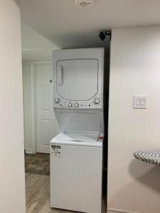 a tv sitting on top of a refrigerator in a room at Guest House Room No 03 in Mississauga