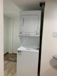 a white tv sitting on top of a refrigerator at Guest House Room No 03 in Mississauga