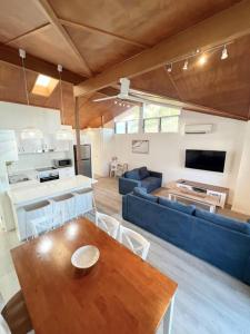 ein Wohnzimmer mit einem Tisch und einem blauen Sofa in der Unterkunft Marlin Villa - Hervey Bay in Urangan