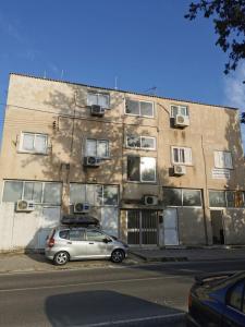 a car parked in front of a building at Strovolos rooms Studios in Nicosia