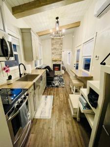a kitchen and living room with a stove and a fireplace at Delightful Tiny Home w/ 2 beds and indoor fireplace in McKinleyville
