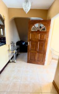 a room with a door and a tile floor at 2 Bed Apartment at the Hideaway in St Mary