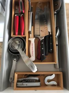 a drawer filled with lots of kitchen utensils at Modern condo steps from the ocean in Anchorage