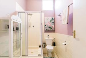 a bathroom with a toilet and a shower at Skyview Manor in Stellenbosch