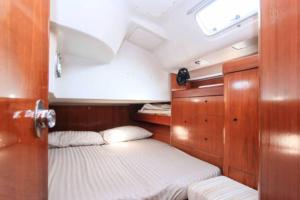 a small room with two beds in a boat at 53ft Sailing Yacht PHUKET Family Sailing adventure in Bang Tao Beach