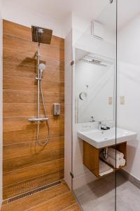 y baño con lavabo y ducha. en H11 ROOMS ESZTERGOM, en Esztergom