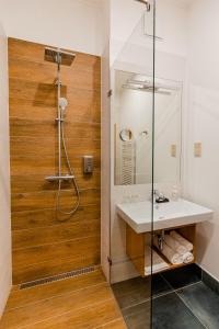 a bathroom with a sink and a shower at H11 ROOMS ESZTERGOM in Esztergom