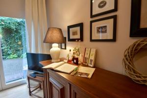 a room with a desk with a lamp and a window at Gästehaus Scholly in Saarlouis