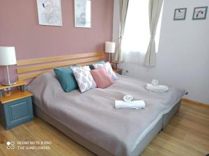 a bedroom with a bed with towels on it at Guest House Sunflowers in Pomorie