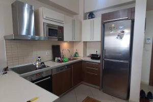 a kitchen with a stainless steel refrigerator and a sink at Amazing view Large 1 bed 1 bath lovely apartment in Esenyurt