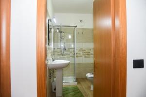 a bathroom with a sink and a shower and a toilet at AF Apartments in Vibo Valentia Marina