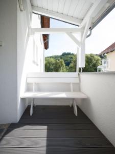 a window with a white bench in a balcony at Ferienwohnung „Prims“ in Wadern