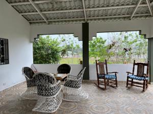 a patio with four chairs and a table at Villa Piña Alojamiento rural in San Rafael