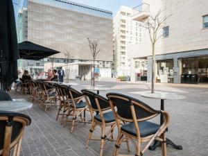 a row of tables and chairs at an outdoor cafe at Sliema Tigne Suites in Sliema