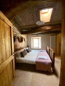 a bedroom with a bed and a table in it at Il Mulino dei Veraghi The Mill at the Falls in Molina