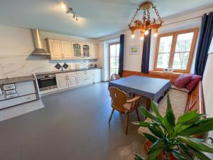 a kitchen with a table and a dining room at Fewo B33 in Übersee