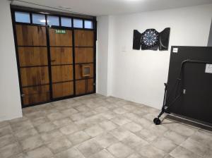 a garage with a door and a dart board on the wall at Casa Rural Sutegia in Ziga +41 photos