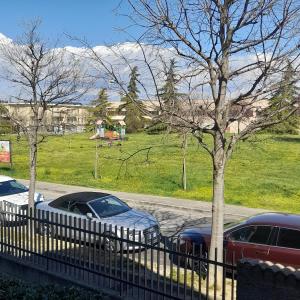 a fence with cars parked in front of a park at garda felice in Desenzano del Garda