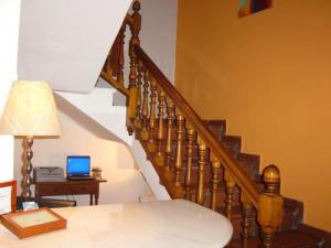 a room with a staircase with a laptop on a table at Hotel Restaurante Rio Cuervo in Vega del Codorno