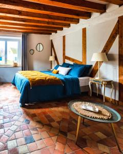 a bedroom with a bed and a table in it at NUITS DE LOIRE -Entre Blois et Chambord in Vineuil