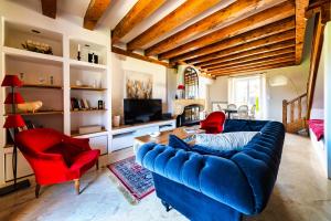 a living room with a blue couch and red chairs at NUITS DE LOIRE -Entre Blois et Chambord in Vineuil