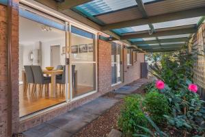 a patio with a table and chairs in a house at The Scotty House - EV and pet friendly in Moss Vale