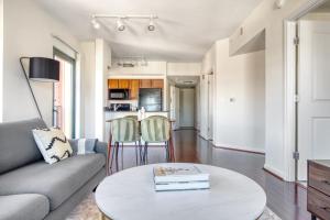 a living room with a couch and a table at Logan Circle 2BR w Gym WD Pool nr bars WDC-481 in Washington, D.C.