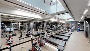 a gym with several treadmills and bikes in it at Logan Circle 2BR w Gym WD Pool nr bars WDC-481 in Washington, D.C.