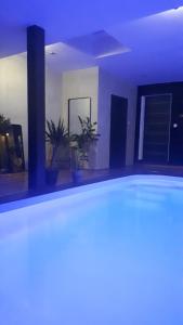 a room with a swimming pool at night at A l'Origine in Lille