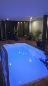 a large swimming pool with blue lighting in a house at A l'Origine in Lille