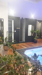 uma sala de estar com piscina e vasos de plantas em A l'Origine em Lille