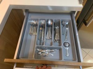 a drawer with silver utensils in a cabinet at Amazing view Large 1 bed 1 bath lovely apartment in Esenyurt